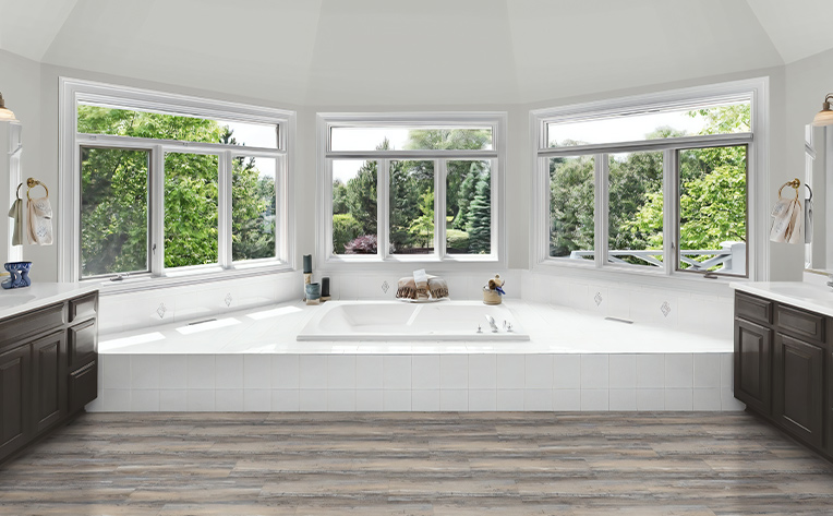 luxury vinyl bathroom with big windows and grey flooring
